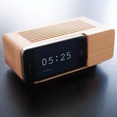 an alarm clock sitting on top of a wooden table