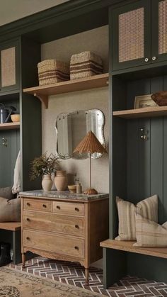 a room filled with lots of wooden furniture and green painted walls next to a rug