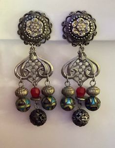 "Gorgeous eye-catching vintage Ann Cichon boho dangle earrings.    The earrings are 3 3/4\" long and 1 1/8\" wide at widest point. One is marked Ann Cichon Dallas.  The item(s) may need a good cleaning. I do not clean items, leaving that to the discretion of the buyer.  Please ask any questions before purchase as there are no returns/refunds. I am not an expert on vintage jewelry. This is from an estate. I am researching as I go.  Only ships to the lower 48 United States, excludes Hawaii and Alaska. Thank you for looking and have a great day." Vintage Pierced Drop Beaded Earrings, Vintage Metal Chandelier Earrings With Dangling Beads, Vintage Nickel-free Drop Beaded Earrings, Vintage Festival Earrings With Dangling Beads, Nickel-free Vintage Drop Beaded Earrings, Vintage Dangle Beaded Earrings For Festival, Vintage Silver Beaded Drop Earrings, Vintage Beaded Dangle Earrings, Handmade Vintage Drop Chandelier Earrings