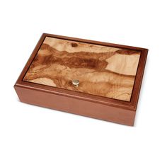 a wooden box with a ring in it on a white background and the lid is made out of wood