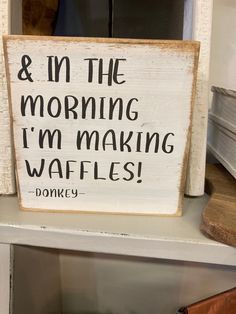 a wooden sign that says and in the morning i'm making waffles