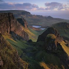 an aerial view of mountains and lakes at sunset