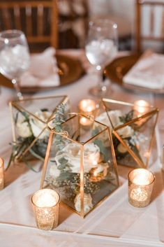 the centerpieces are filled with candles and flowers