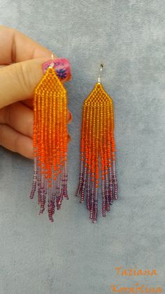 These unique handmade earrings are made of high-quality Czech beads and strong synthetic thread. They are elegant, fashionable, and highly versatile, suitable for everyday wear. Color: orange, purple . There may be some color discrepancies which is due to the different monitor settings I will make these earrings for you in your favorite size. 100% hand made with love! Measurements: Length-about 10,5cm (4.13 inch) Width -about 2 cm (0.79 inch) Materials: Sterling silver components Czech glass bea Handmade Purple Tassel Earrings With Round Beads, Handmade Purple Tassel Earrings, Orange Handwoven Dangle Beaded Earrings, Handmade Purple Dangle Tassel Earrings, Adjustable Orange Tassel Earrings, Orange Handwoven Beaded Earrings, Handwoven Orange Beaded Earrings For Gift, Handmade Purple Beaded Earrings For Beach, Handwoven Orange Beaded Earrings As Gift