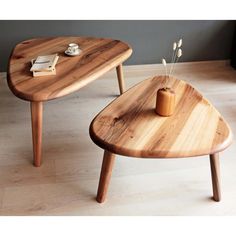 two wooden tables sitting on top of a hard wood floor