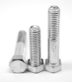 two screws are sitting next to each other on a white surface, with one bolt in the middle