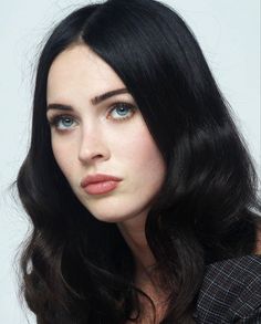 a woman with long black hair and blue eyes