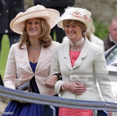 two women in hats are standing next to each other