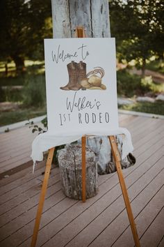 a baby shower sign sitting on top of a wooden easel