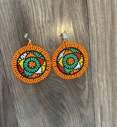 These gorgeous traditional beaded Zulu disc earrings are a gorgeous statement piece must haves.  Please note each piece is handmade and slight variations may occur. Traditional Beaded Hoop Earrings, Handmade Earrings With Round Beads For Festivals, Handmade Earrings For Festivals, Traditional Beaded Hoop Earrings For Festive Occasions, Traditional Festive Beaded Hoop Earrings, Bohemian Earrings With Large Round Beads, Artisan Multicolor Round Beaded Earrings, Traditional Beaded Earrings With Round Beads, Colorful Round Beaded Earrings