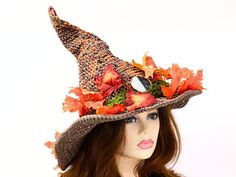 Ready for the Renfaire, a festival, cosplay, a pagan celebration, your table centerpiece, or just plain fun, this witch or wizard hat is covered in gloriously detailed Fall leaves, with moss running through them all the way around the hat. A stone symbol of balance serves as the talisman. The brim is wired and I gave it an open stitch for extra ventilation and a rustic feel. I made this in a blend of cotton and hand-dyed merino so you can wear it year round. The way I stitch allows you to twist Witchy Costume Hats With Curved Brim For Fall, Witchy Costume Hat For Fall, Curved Brim Costume Hats And Headpieces For Fall, Themed Costume Hats And Headpieces For Halloween, Adjustable Mini Hats For Fall Costume Party, Fall Costume Hats And Headpieces With Curved Brim, Curved Brim Costume Hats For Fall, Themed Halloween Festival Costume Hats And Headpieces, Adjustable Mini Hats For Fall Costume