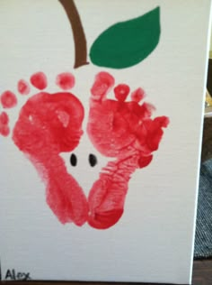 an apple hand and foot print on a canvas