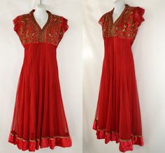 Vintage Lipstick Red Bollywood Empire Waist Dress Lipstick red dress with detailed embroidery, beads and rhinestone design all over the velvet bodice. Eye hook closure at the back of the neck. A sheer outer layer that features a velvet near the hem of the dress. Label: Unknown - No Tag Present Measurements are taken flat; Shoulders: 16 inches Sleeve: 2 inches Cuff: 6 1/4 inches Neck: 7 1/2 inches Bust: 18 inches Waist: 14 inches Hips: 20 inches Length (shoulder to hem): 48 1/2 inches Condition M Bollywood Sequin V-neck Dress, Festival Anarkali Dress With Embroidered Neckline, Anarkali Dress With Embroidered Neckline For Festivals, Festive Bollywood Dress With Embroidered Neckline, Elegant Dresses With Embroidered Neckline For Festivals, Elegant Embroidered Neckline Dress For Festivals, Bollywood Wedding Dress With Embroidered Neckline, Fitted Anarkali Dress With Embroidered Neckline, Red Anarkali Dress With Sequins