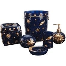 a blue bathroom set with gold stars on it