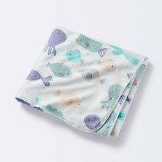 two baby swaddles on top of each other with an elephant and fish print