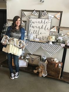 a woman standing in front of a table filled with balloons and gifts for someone's 30th birthday