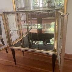 an old fashioned glass display case on wooden floor