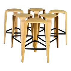 four wooden stools sitting next to each other