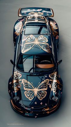 the top view of a car with butterflies painted on it's body and hood