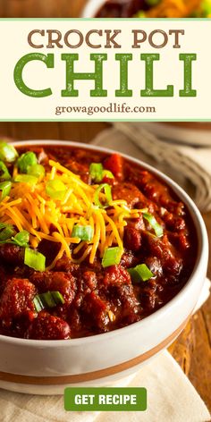 the recipe for crock pot chili is in a bowl with cheese and green onions