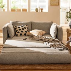 a living room filled with furniture and pillows