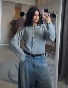 a woman taking a selfie in front of a mirror