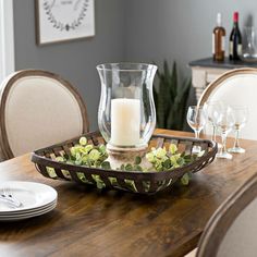 a wooden table topped with plates and glasses