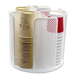 several cups and plates in a holder on a white surface with red trimmings