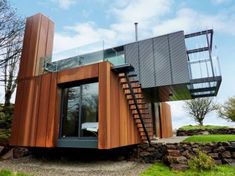 a modern house with wood and glass on the roof, stairs leading up to it