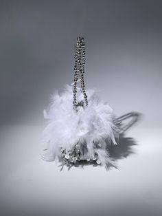 The Martina Sequin Feather Shoulder Bag is a stylish and sophisticated accessory crafted with shimmering sequin and beautiful beaded detail, accented with a unique feather inspired design. An ideal way to accessorize any outfit, this shoulder bag offers both luxury and fashion. Material: Sequin 7.1 inch / 18cm diameter (dimensions approx.) Luxury Formal Bags With Feathers, Luxury Formal Feathered Bags, Luxury Evening Bags With Feather Trim, Luxury Evening Bag With Feather Trim, Elegant Bags With Feather Trim For Events, Elegant Evening Bags With Feathers, Sequin Shoulder Bag For Wedding, Formal Chic Bags With Feathers, Chic Formal Bags With Feathers