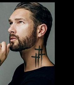 a man with a cross tattoo on his neck