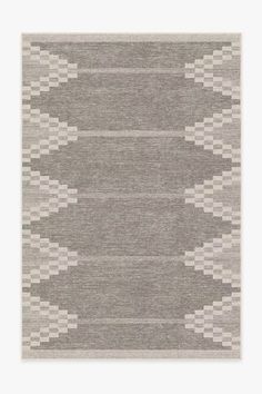 an area rug with grey and white designs on the front, in two different colors