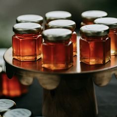 honey jars are sitting on a metal tray