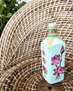 a blue vase sitting on top of a wicker chair