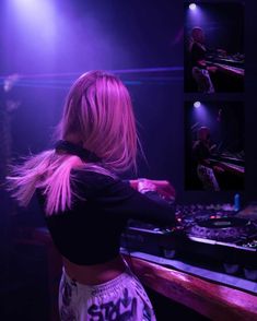 a woman with long blonde hair is playing music on the dj's mixers