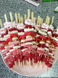 several skewers are arranged on a plate with toothpicks in the shape of letters