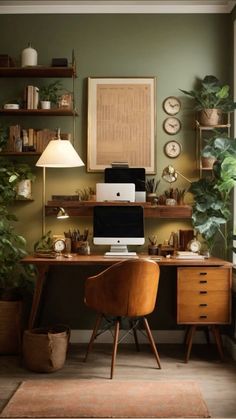 a home office with green walls and lots of plants on the desk, along with a computer