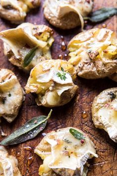 baked potatoes with cheese and herbs on a wooden cutting board, ready to be eaten