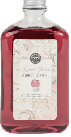 a bottle of liquid with flowers on it