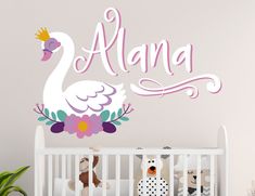 a baby's name wall decal with a swan and flowers