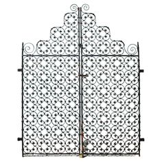 an iron gate with intricate designs on the top and bottom bars, set against a white background