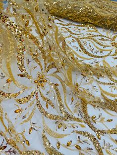 gold sequins and beads on white fabric