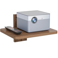 a small projector sitting on top of a wooden shelf next to a remote control