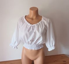 "Vintage Women Dirndl Crop Top/Blouse/Shirt/Short Top Brand: Tergal. Material: 33% cotton, 67% polyester. Size: M/40. White color. Short sleeve. Elastic hem. Ruffles. Elastic waist. Measurements: laying flat and doubled where necessary. armpit to armpit: 48 cm (18.89\") sleeve length: 38 cm (14.96\") length from shoulder to hem: 44 cm (17.32\") shoulder to shoulder: 37 cm (14.56\") Great vintage condition." White Cropped Blouse, Fitted Peasant Top With Ruffles, Fitted Peasant Dress For Daywear, Fitted Smock Peasant Dress, Shirt Under Dress, White Ruffle Blouse, Peasant Shirt, Cropped Blouse, Blouse Short Sleeve