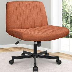 an orange office chair sitting on top of a white rug