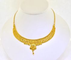 22k Gold 15" Ornate Handmade Necklace. 20.8grams Add a touch of elegance to your outfit with this stunning 22k gold necklace. Crafted by hand, this necklace features an ornate design that is sure to catch the eye. The necklace is 15 inches in length and made with yellow gold, giving it a luxurious look. The necklace is perfect for any occasion and would make a great addition to any jewelry collection. The Estate brand is known for its high-quality jewelry, and this necklace is no exception. Whether you're looking for a special gift or just want to treat yourself, this necklace is sure to impress. The necklace has a solid weight of 20.8grams.  We are a small family owned business located in Massapequa, N.Y. Customer satisfaction is our number one goal, and we will do everything we can to en 22k Yellow Gold Bridal Necklace For Festivals, 22k Gold Chain Necklace For Wedding, Traditional Yellow Necklace With Intricate Design, 22k Gold Yellow Necklaces For Wedding, 22k Yellow Gold Temple Necklace With Intricate Design, Yellow Gold Filigree Necklace For Festivals, 22k Gold Temple Necklace For Formal Festivals, 22k Gold Yellow Necklace For Wedding, Yellow 22k Gold Necklace For Wedding