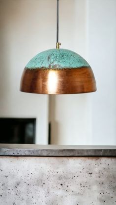 a light that is hanging from a ceiling in a room with concrete walls and flooring