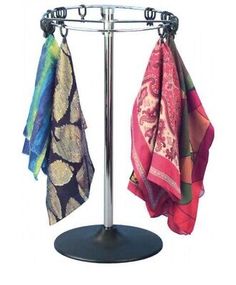 three towels are hanging on a metal rack with two different colored scarves attached to it