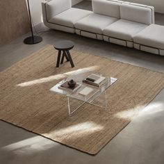 a living room with a couch, coffee table and other items on the rugs