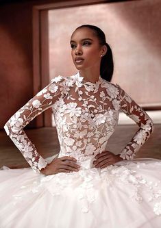 a woman in a wedding dress posing for the camera